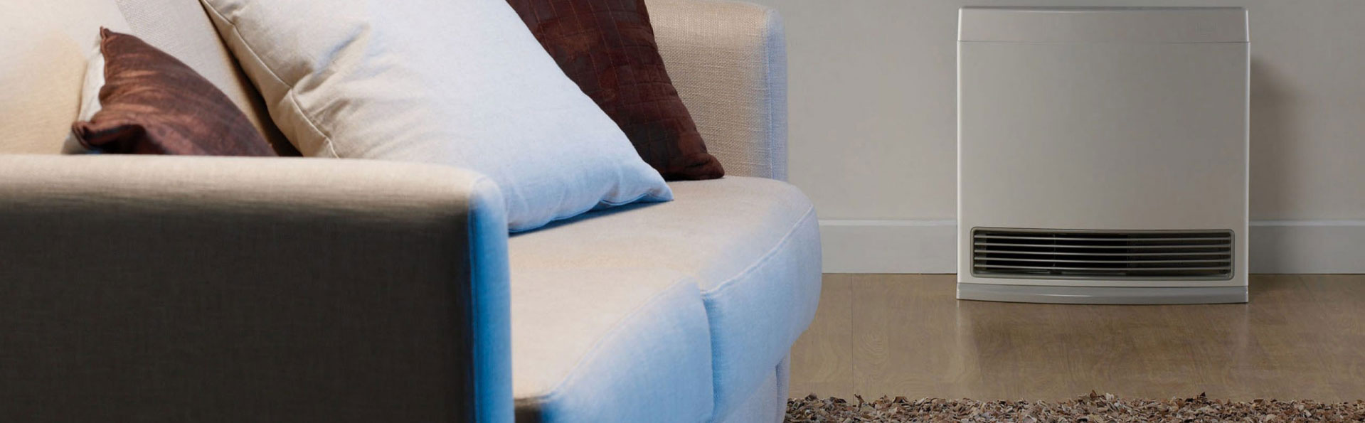 Couch with a heater against the wall in the background