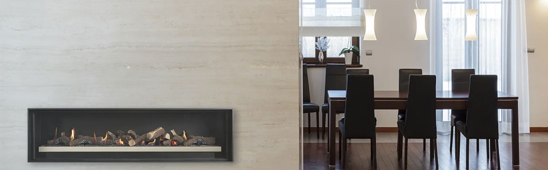 Fireplace on wall and view into the dining room with table and chairs