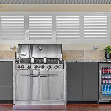 Front on view of BBQ, cabinets and fridge